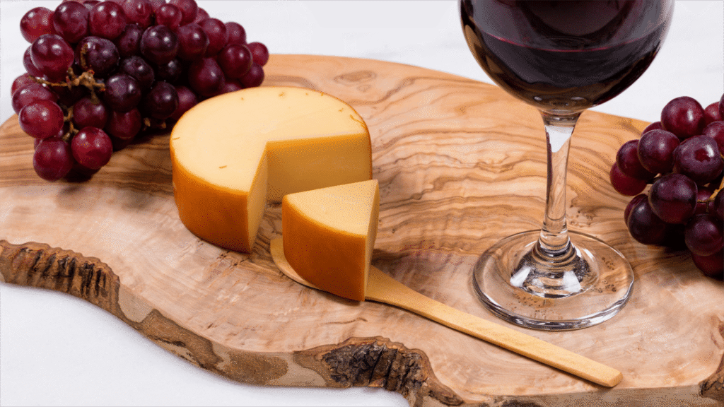 Aged cheddar and gouda cheese with a glass of Cabernet Sauvignon
