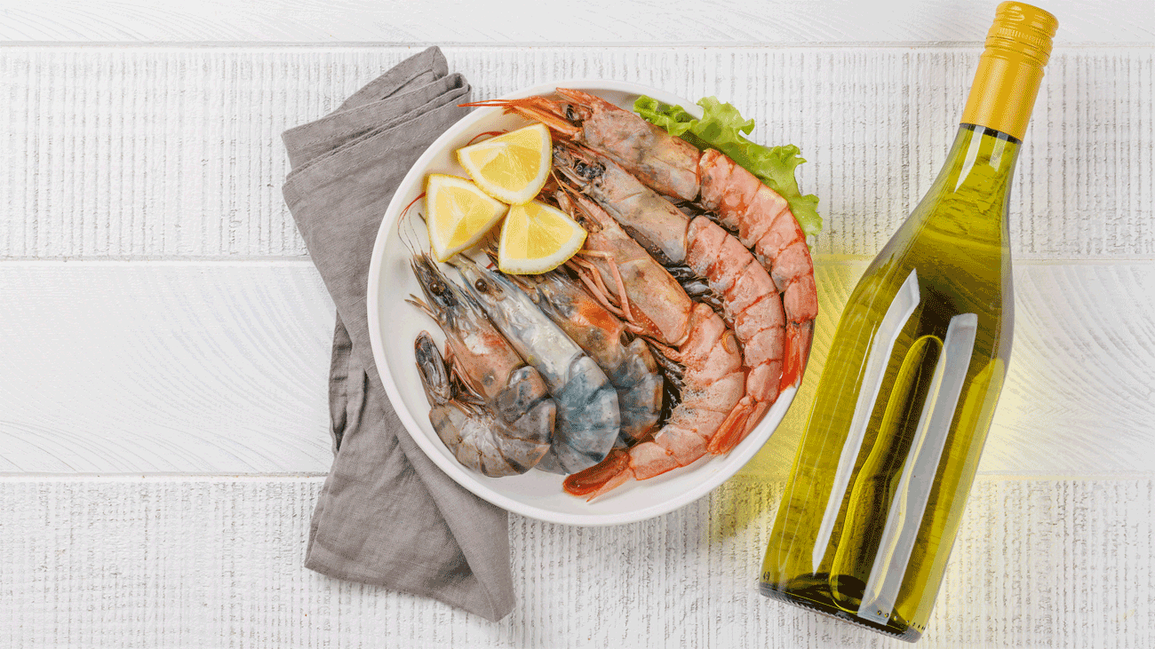 Shrimp scampi with a glass of white wine on a dinner table